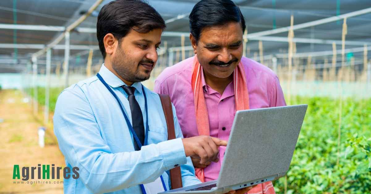 Agriculture professional providing knowledge to farmer on a laptop