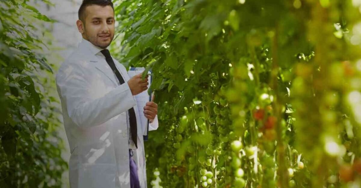 An Agri Professional wearing a white coat